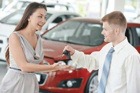 Women buying a car taking their car keys